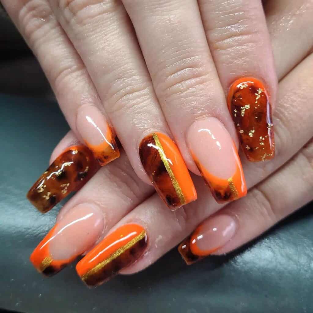 Chic summer nails featuring vibrant orange hues, from neon to burnt with glitter accents, perfect for adding a seasonal touch.