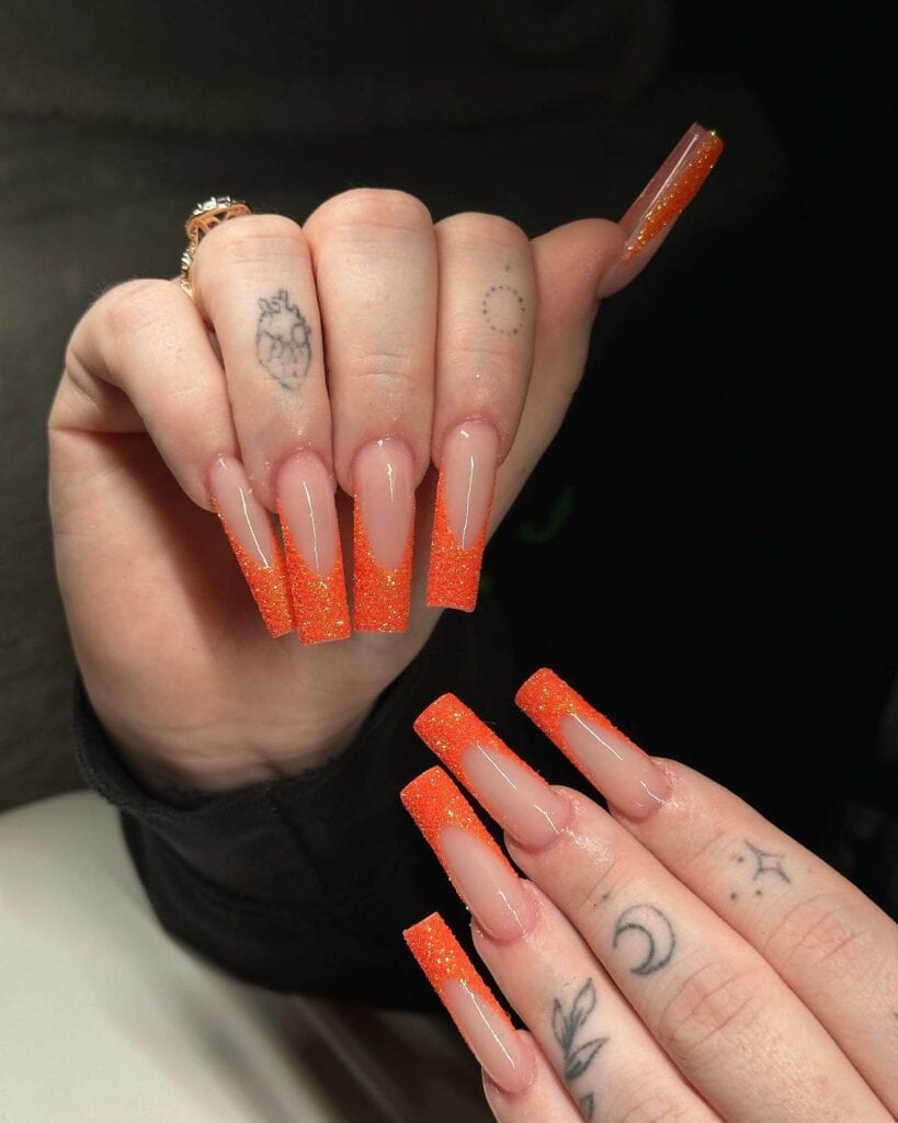 Chic summer nails featuring vibrant orange hues, from neon to burnt with glitter accents, perfect for adding a seasonal touch.